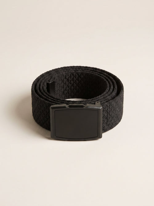 Urban Chic belt coiled on a plain studio background